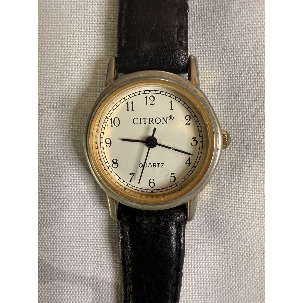 Citron Vintage Women’s Watch, White dial and gold casing. Black leather band.